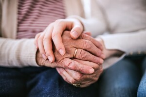 Hands of teenage girl and her grandmother at home