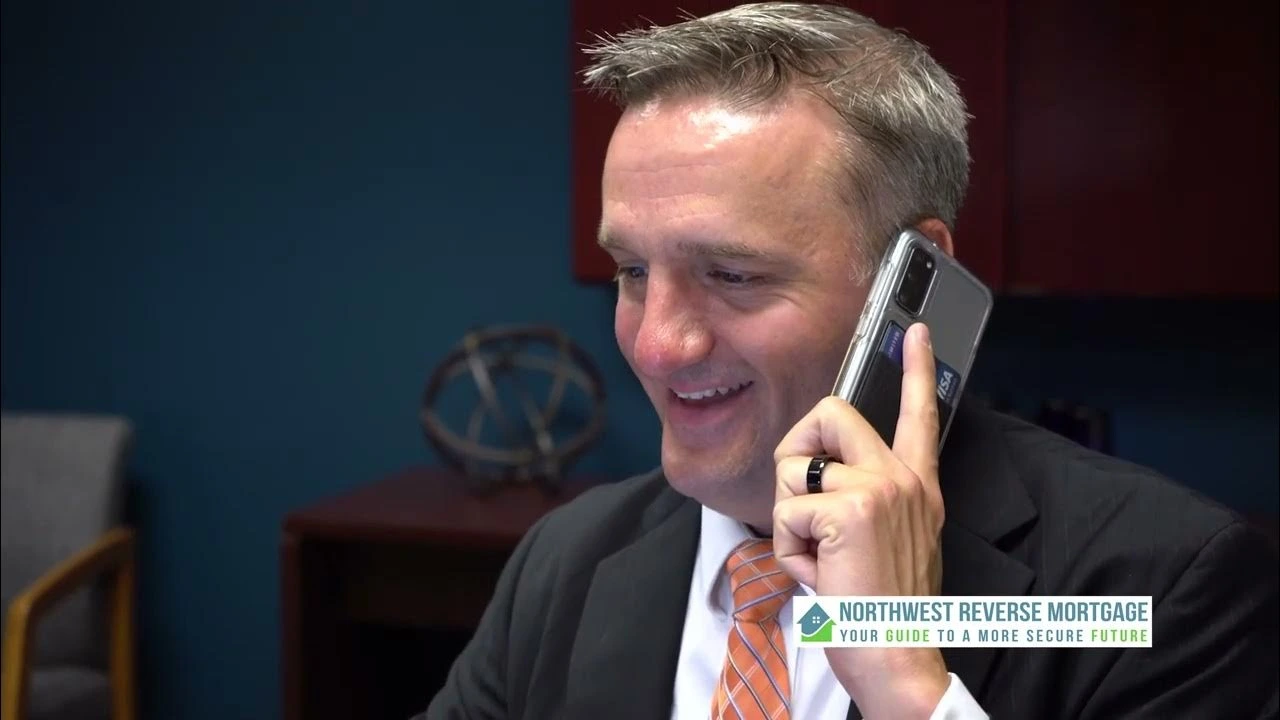 Man in suit talking on phone smiling in office